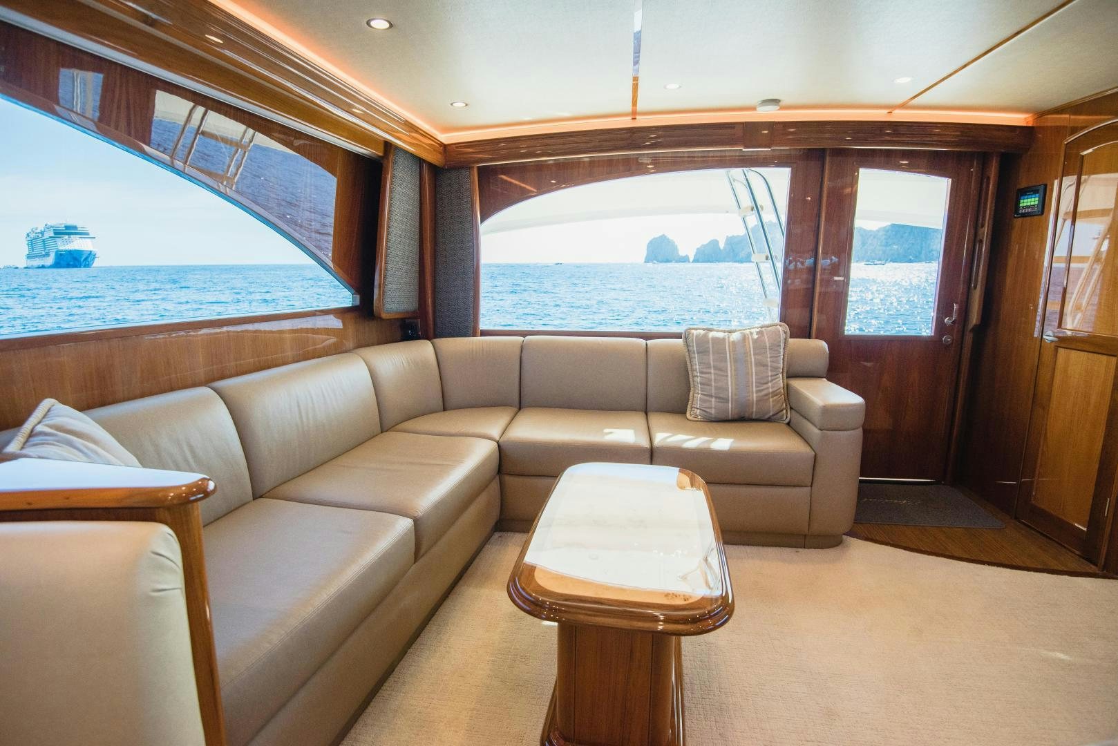 a couch and a table in a room with a view of the water aboard C STUDENT Yacht for Sale