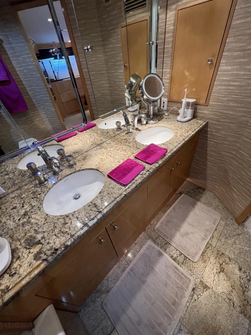 a bathroom with a countertop sink and a large mirror aboard LUCKY JOE Yacht for Sale