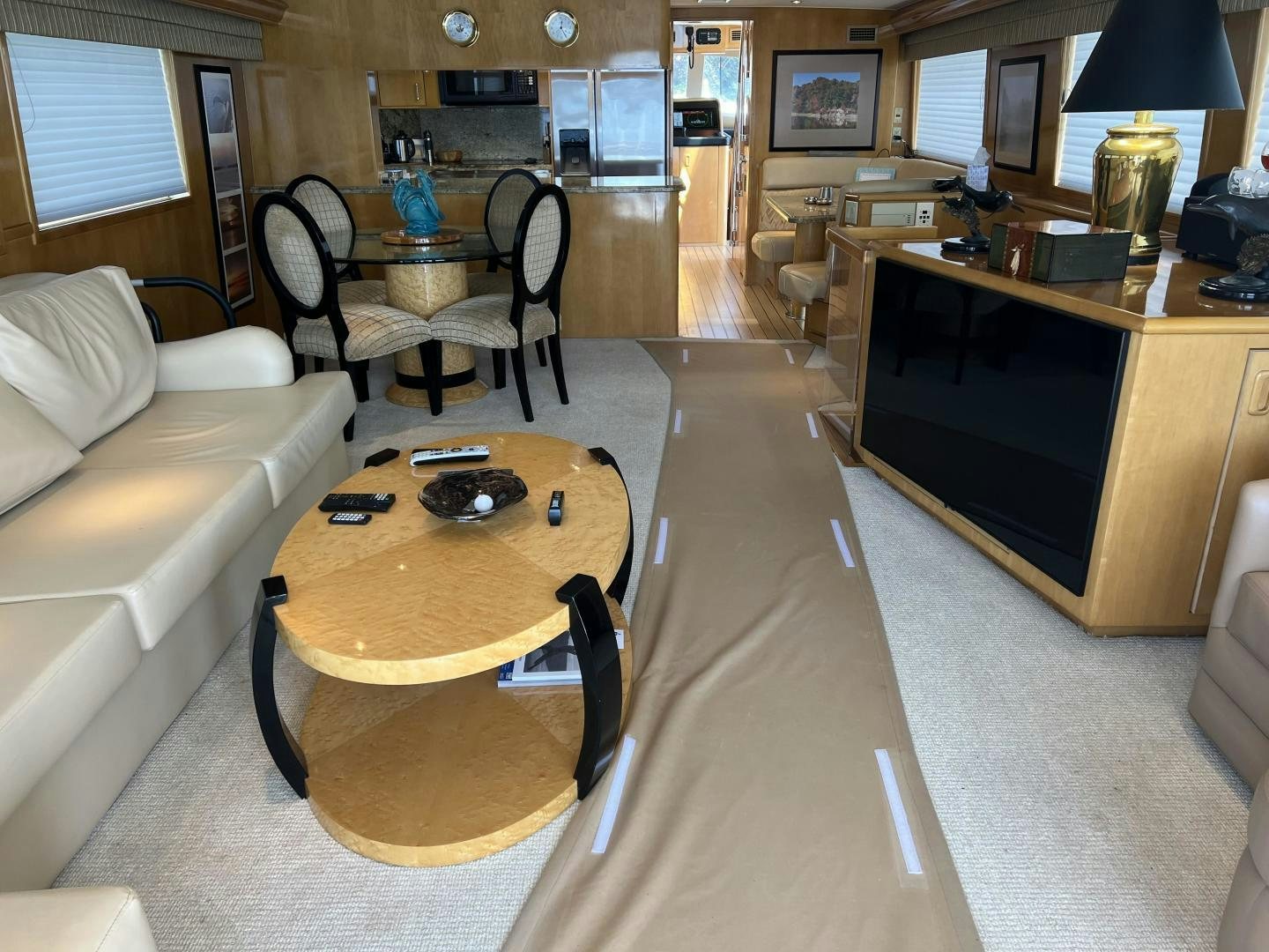 a living room with a table and couches aboard LUCKY JOE Yacht for Sale