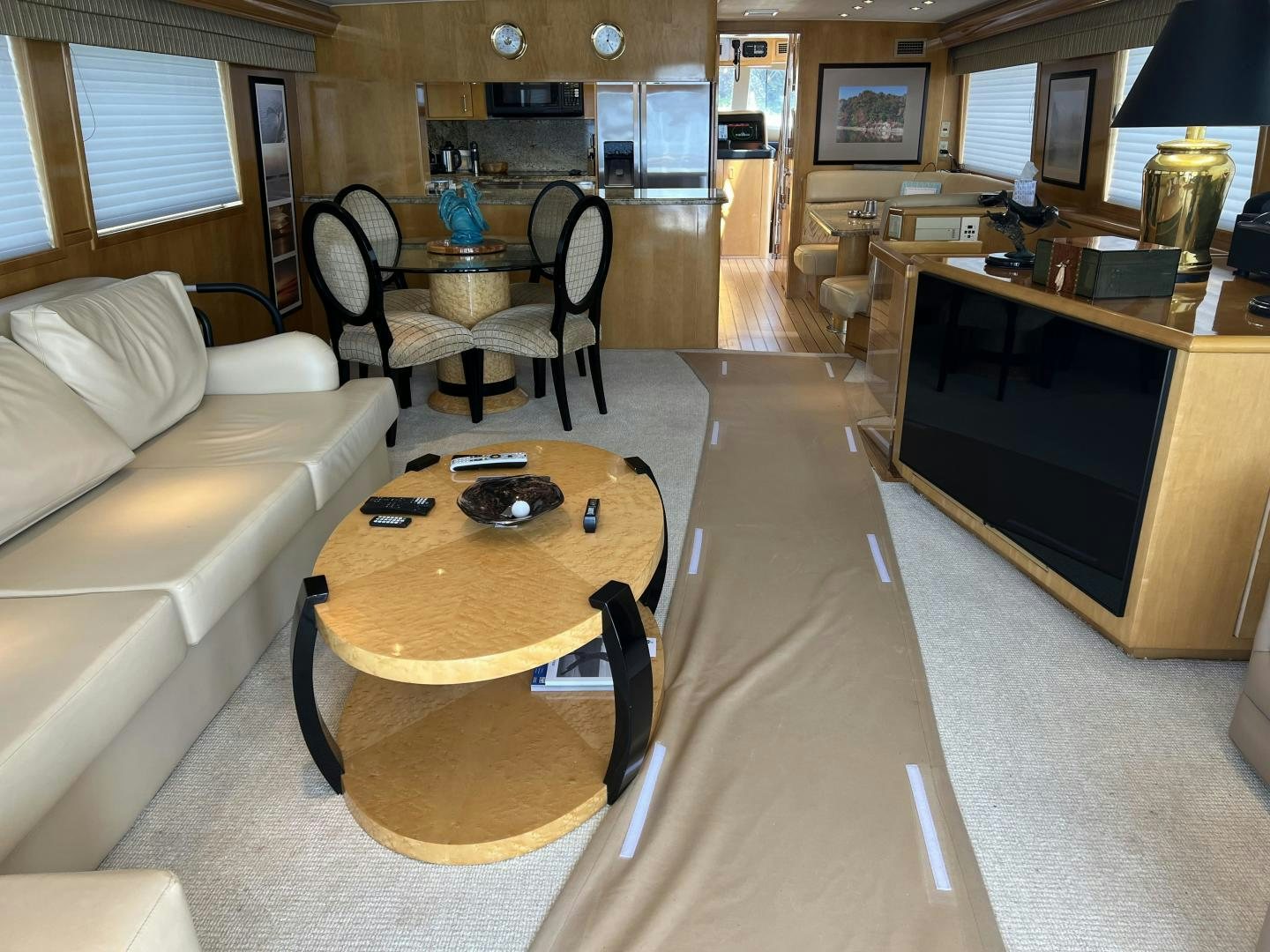 a living room with a table and couches aboard LUCKY JOE Yacht for Sale