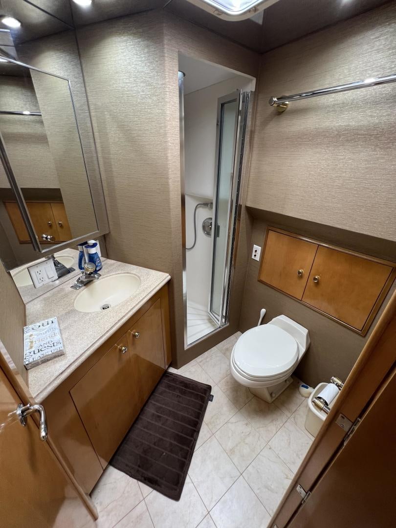 a bathroom with a sink toilet and a mirror aboard LUCKY JOE Yacht for Sale