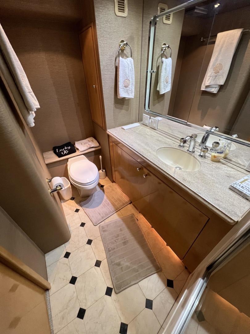 a bathroom with a sink and a mirror aboard LUCKY JOE Yacht for Sale