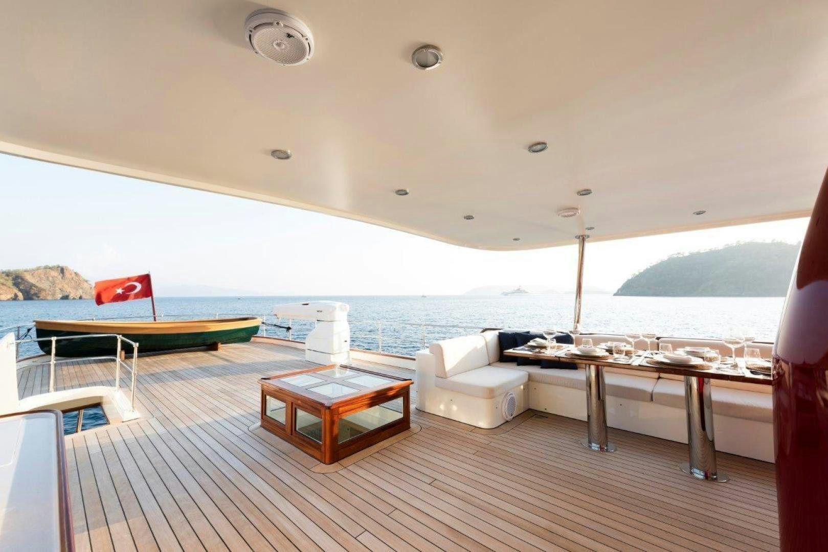 a room with a table and couch aboard MAGNOLIA ONE Yacht for Sale