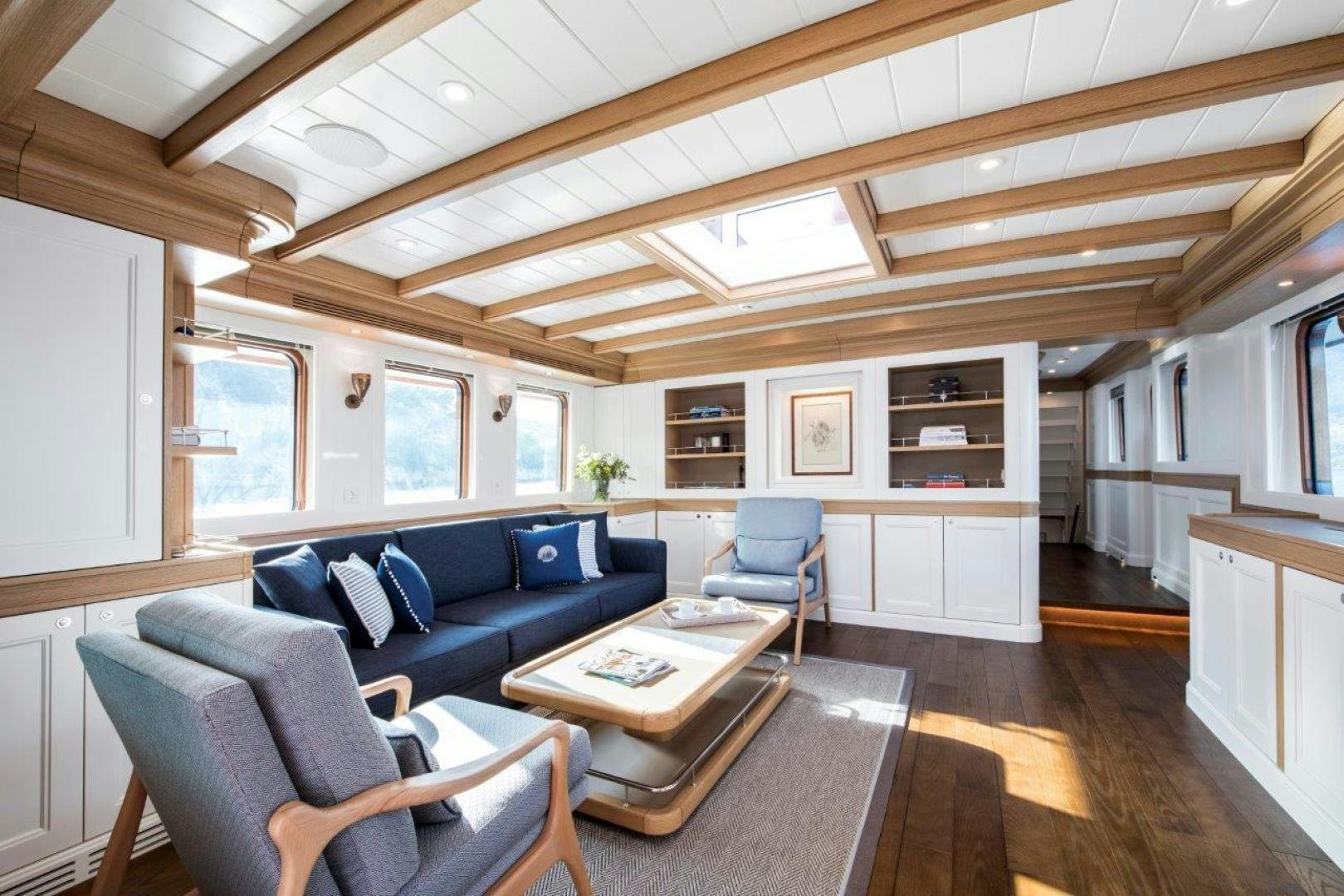 a living room with a couch and a coffee table aboard MAGNOLIA ONE Yacht for Sale