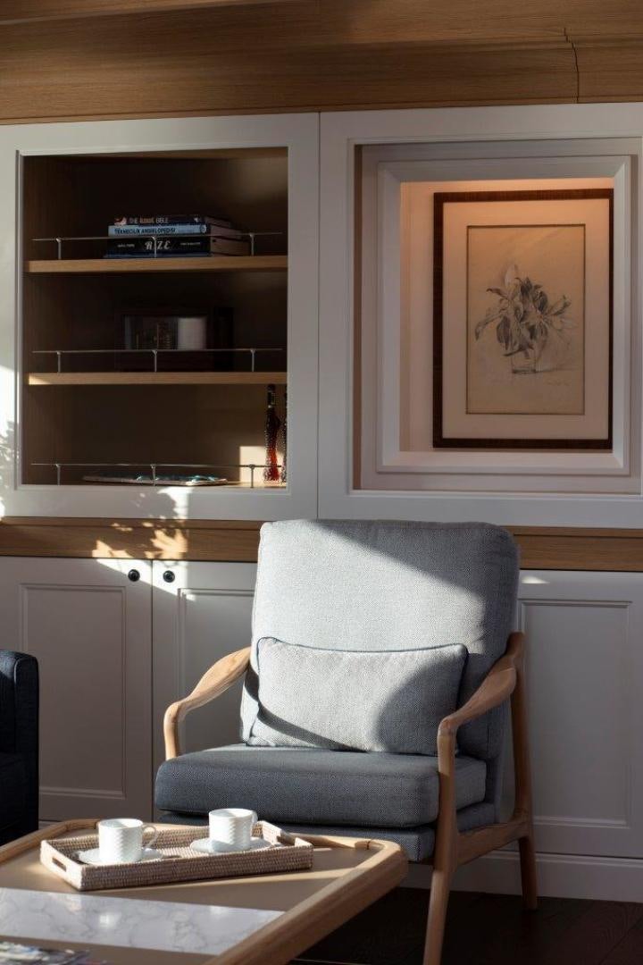 a chair with a table and a picture on it aboard MAGNOLIA ONE Yacht for Sale