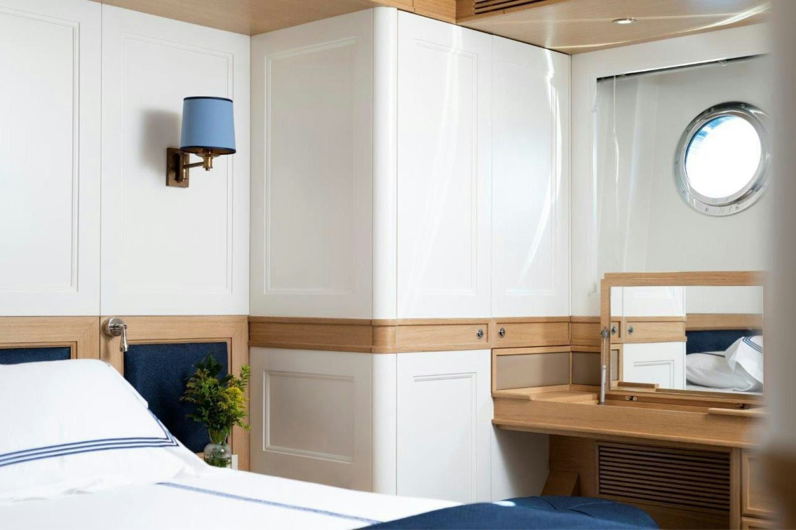 a room with a bed and a desk aboard MAGNOLIA ONE Yacht for Sale