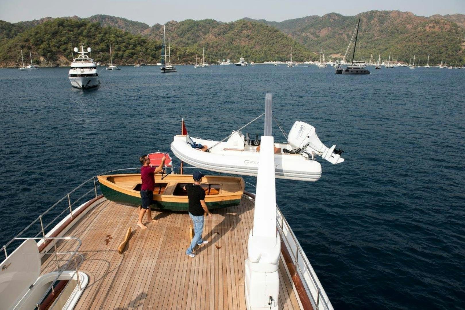 a couple of people on a dock with boats in the water aboard MAGNOLIA ONE Yacht for Sale