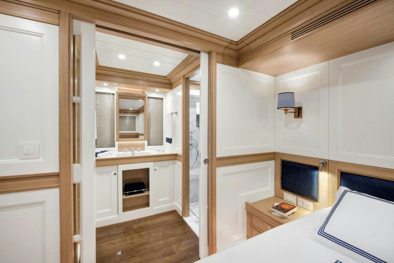 a room with a bed and a desk aboard MAGNOLIA ONE Yacht for Sale