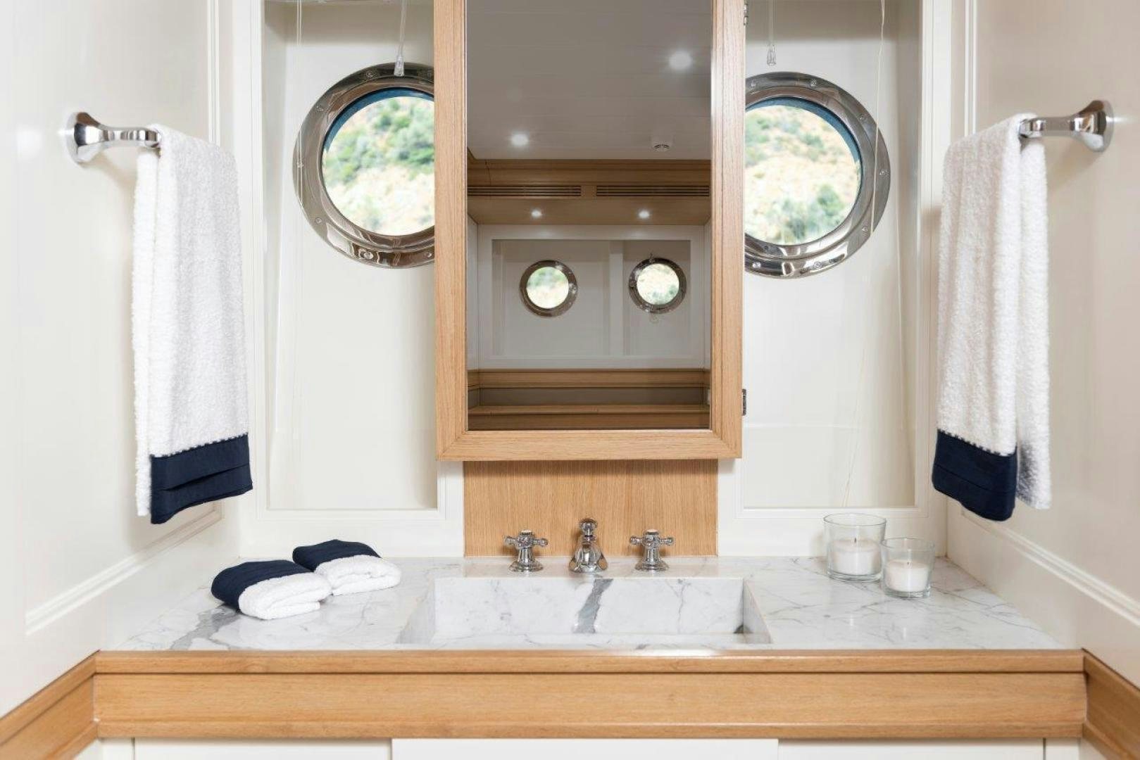 a bathroom with a large mirror aboard MAGNOLIA ONE Yacht for Sale