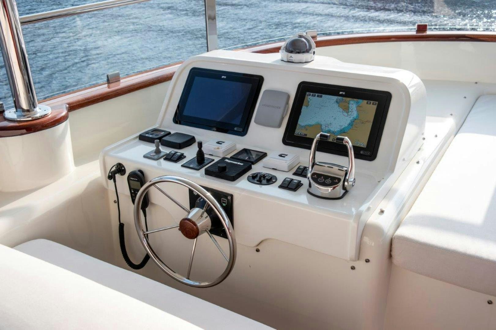 a boat with a steering wheel and a screen on the front aboard MAGNOLIA ONE Yacht for Sale