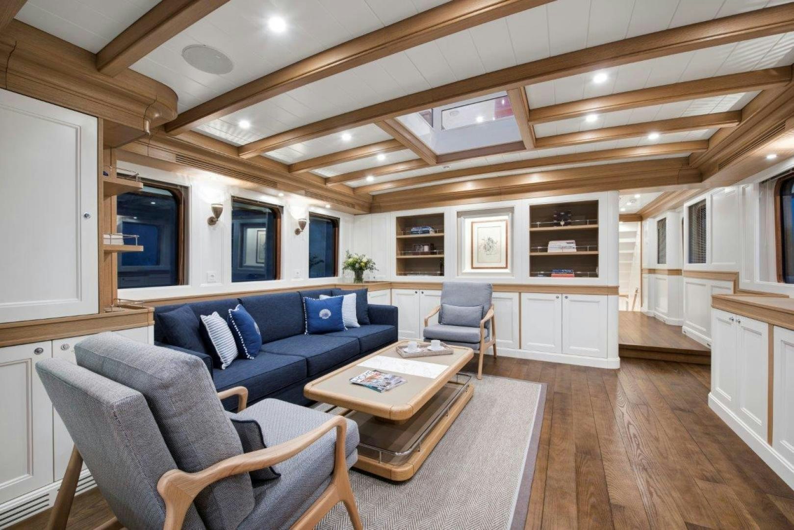 a living room with a blue couch aboard MAGNOLIA ONE Yacht for Sale