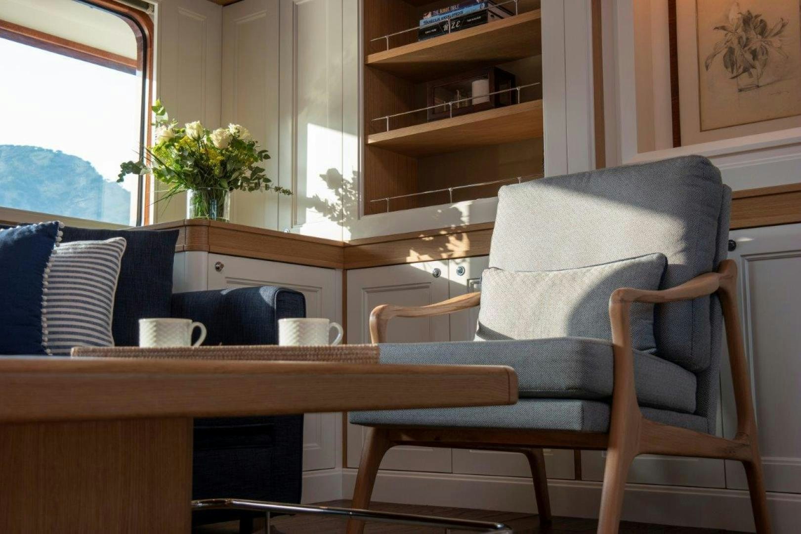 a chair and a table in a room aboard MAGNOLIA ONE Yacht for Sale