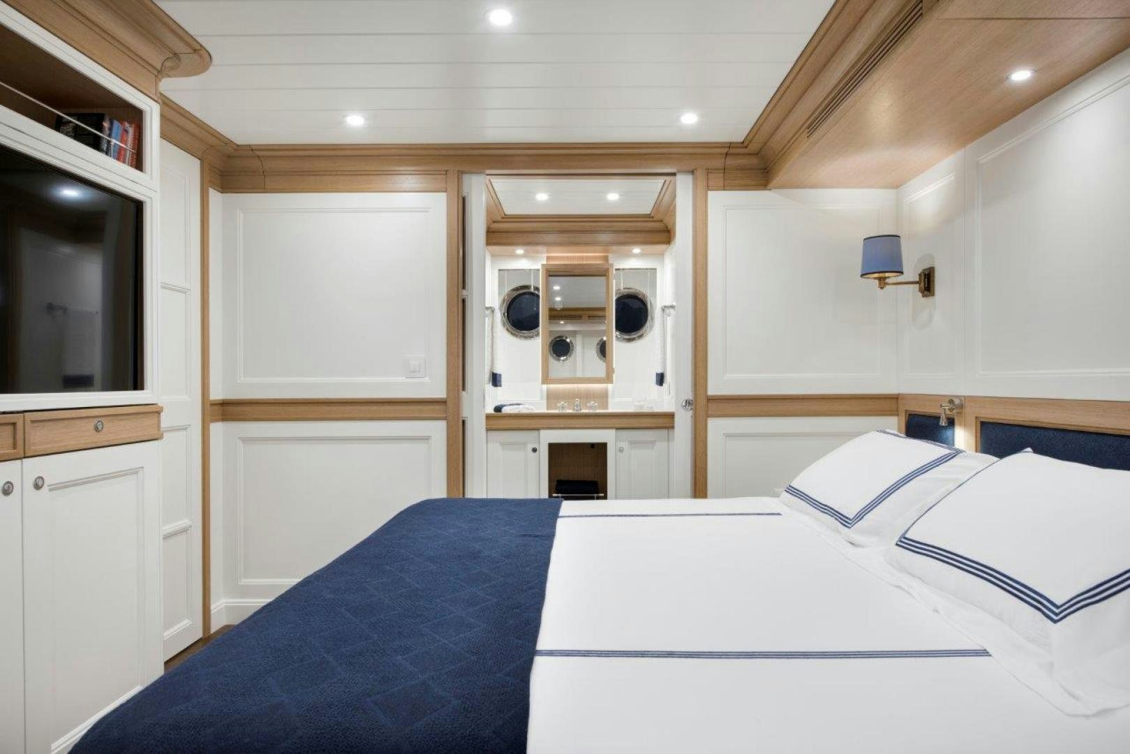 a room with a bed and a mirror aboard MAGNOLIA ONE Yacht for Sale