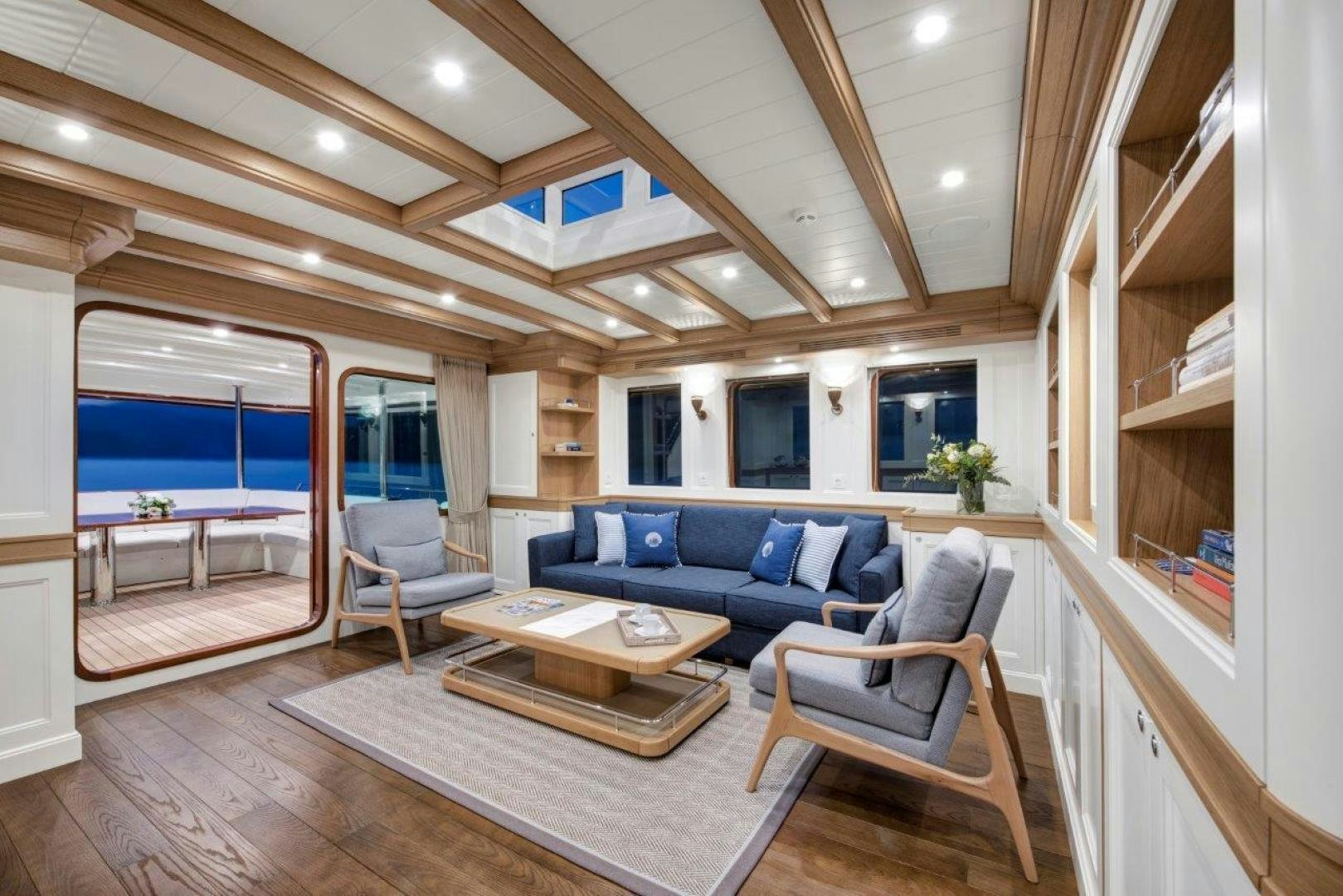 a living room with a wood floor aboard MAGNOLIA ONE Yacht for Sale