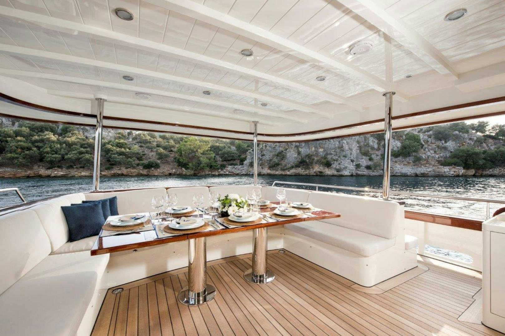 a room with a table and chairs aboard MAGNOLIA ONE Yacht for Sale