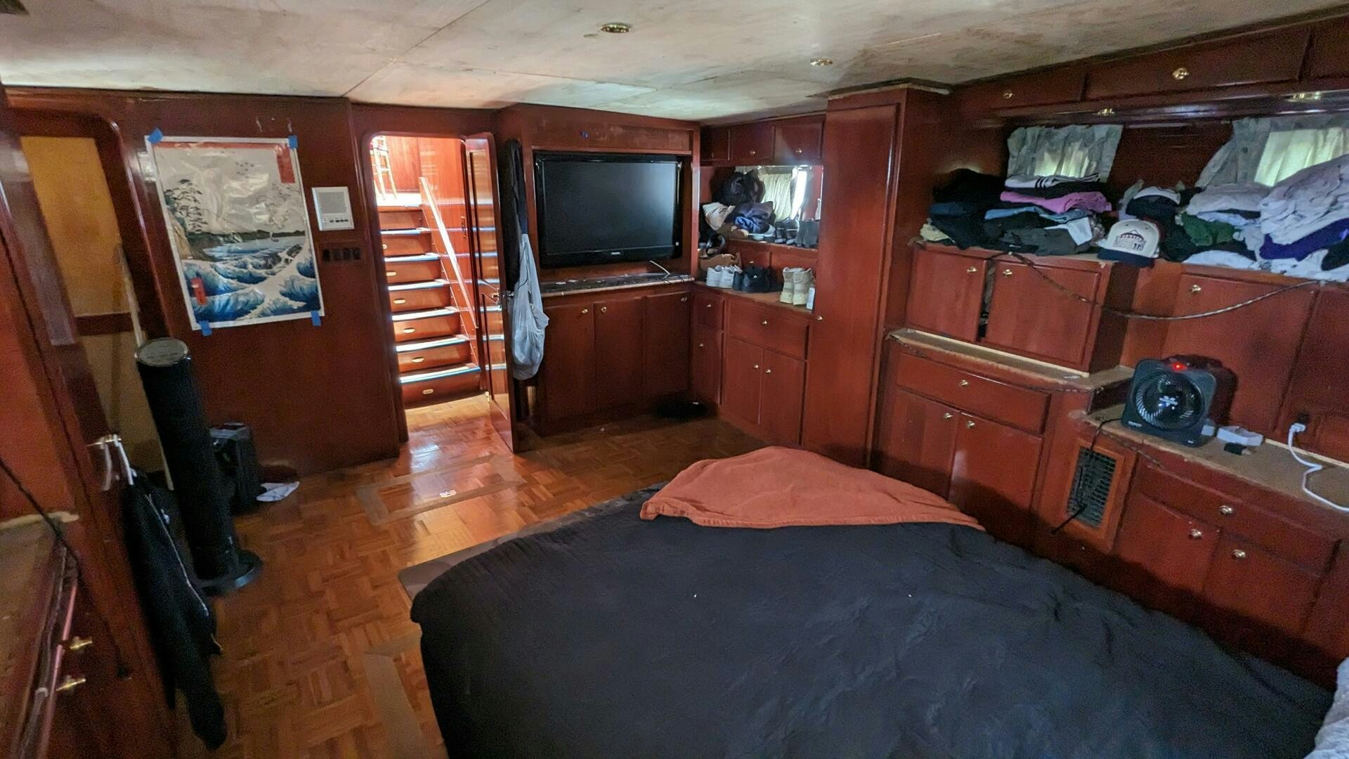 a bedroom with a bed and a television aboard ISABELLA Yacht for Sale