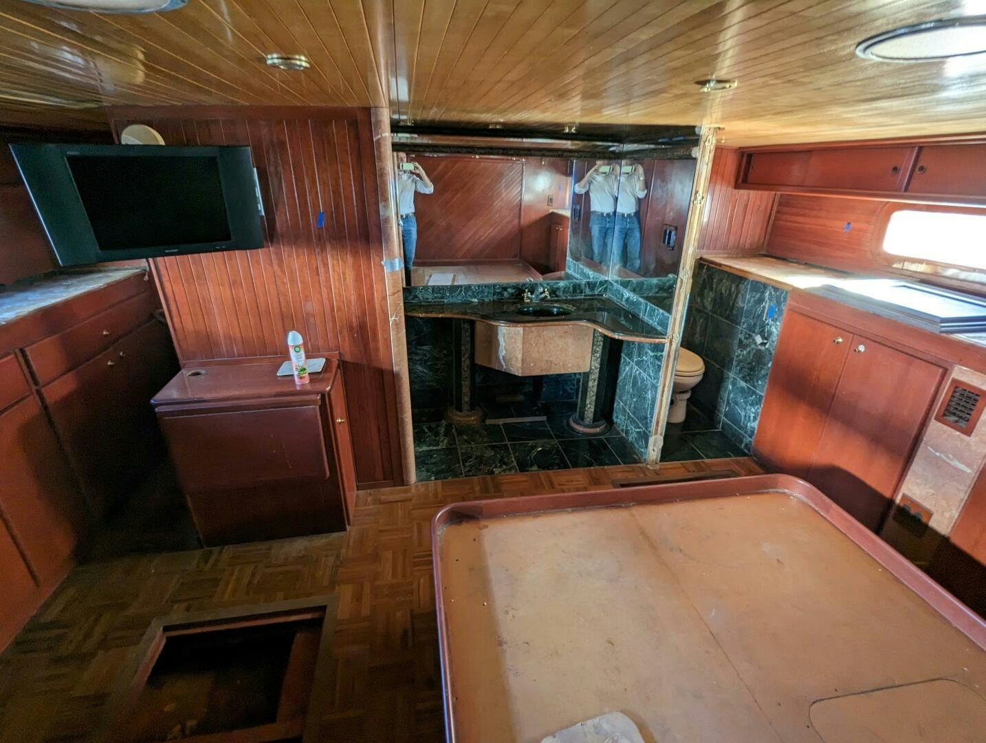 a room with a wood floor and a bed and a desk aboard ISABELLA Yacht for Sale