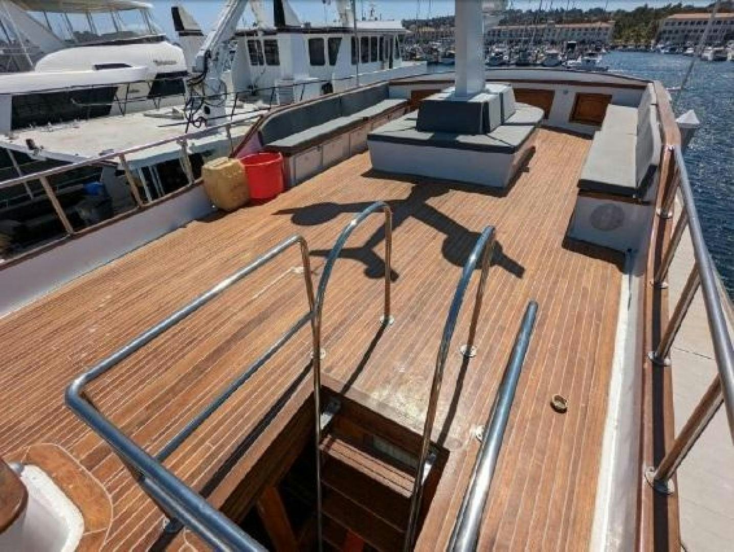 a deck with a deck and a boat in the water aboard ISABELLA Yacht for Sale