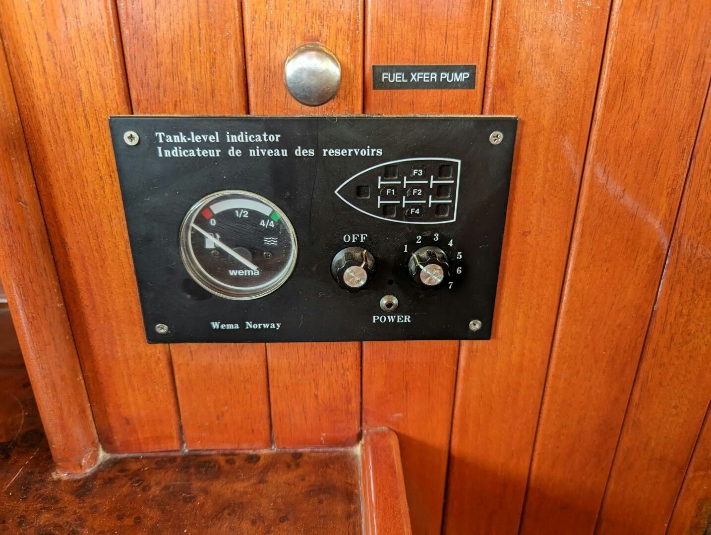 a black rectangular device on a wooden surface aboard ISABELLA Yacht for Sale