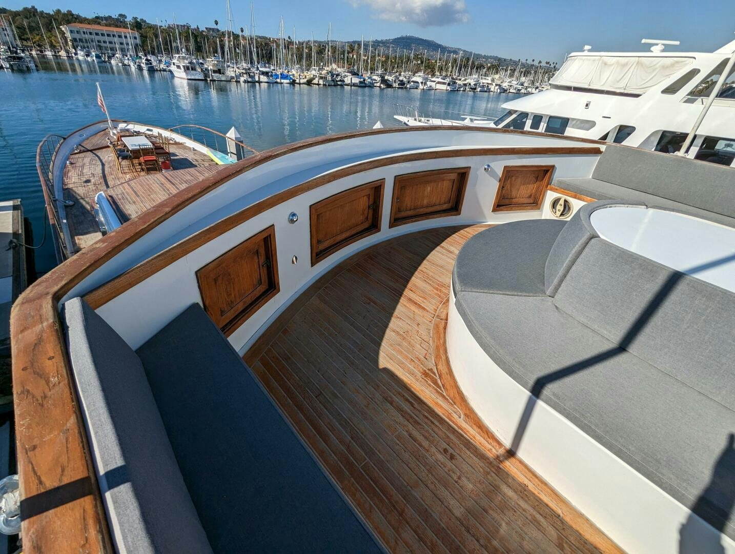 a deck with a view of a city and a large body of water aboard ISABELLA Yacht for Sale