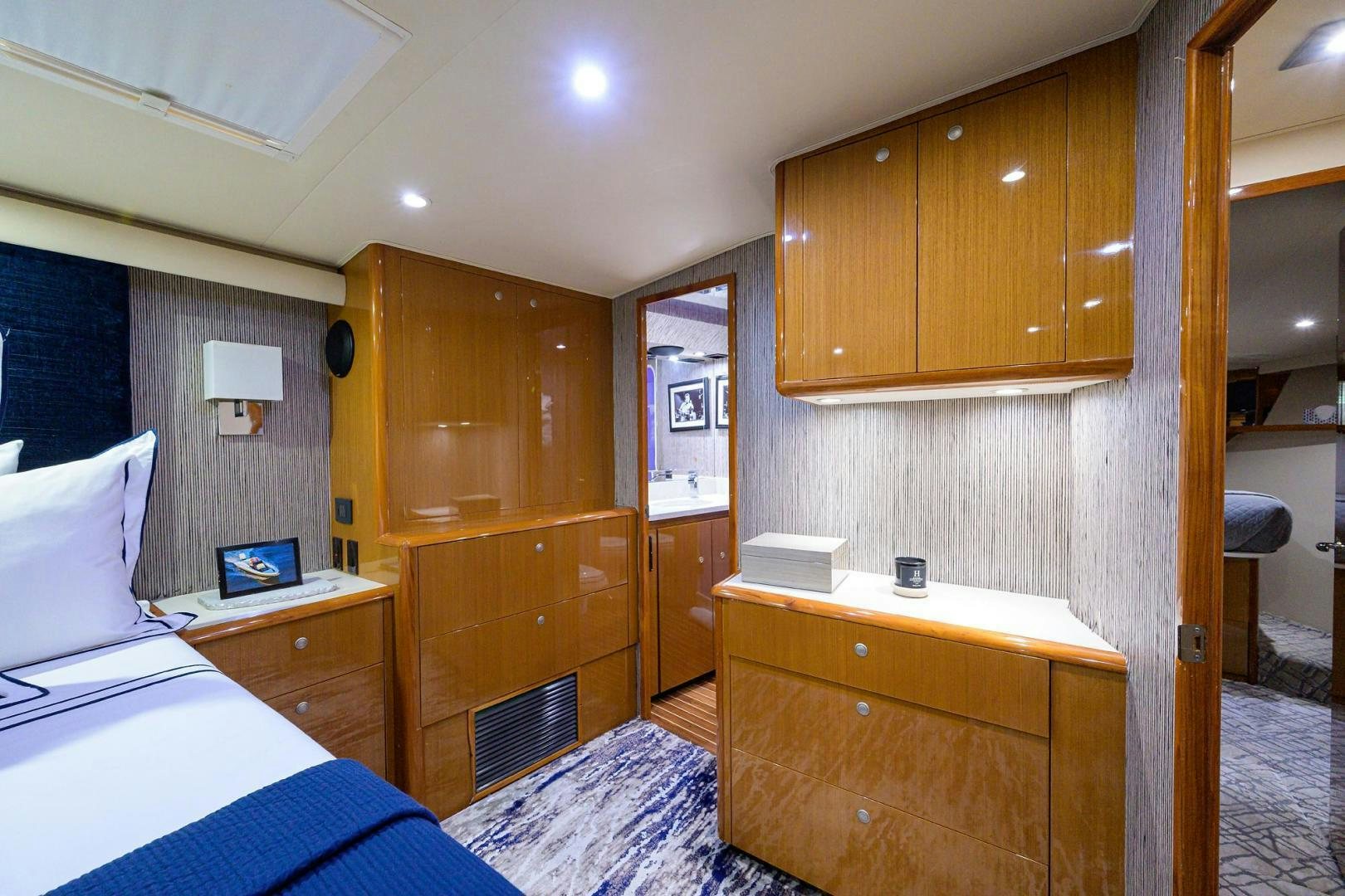 a bedroom with a desk and a bed aboard VAGRANT Yacht for Sale
