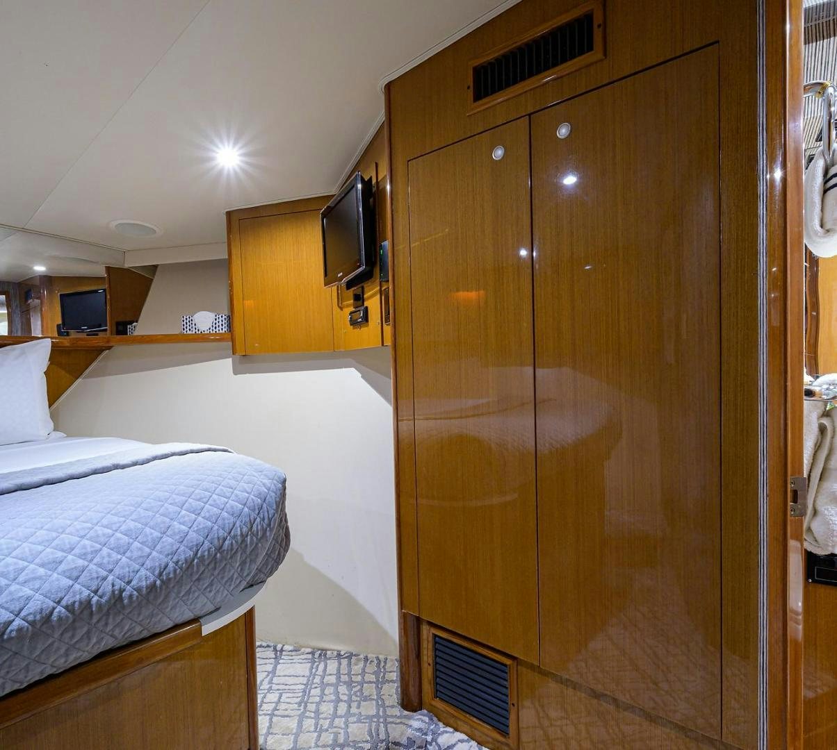 a bedroom with a closet and a bed aboard VAGRANT Yacht for Sale