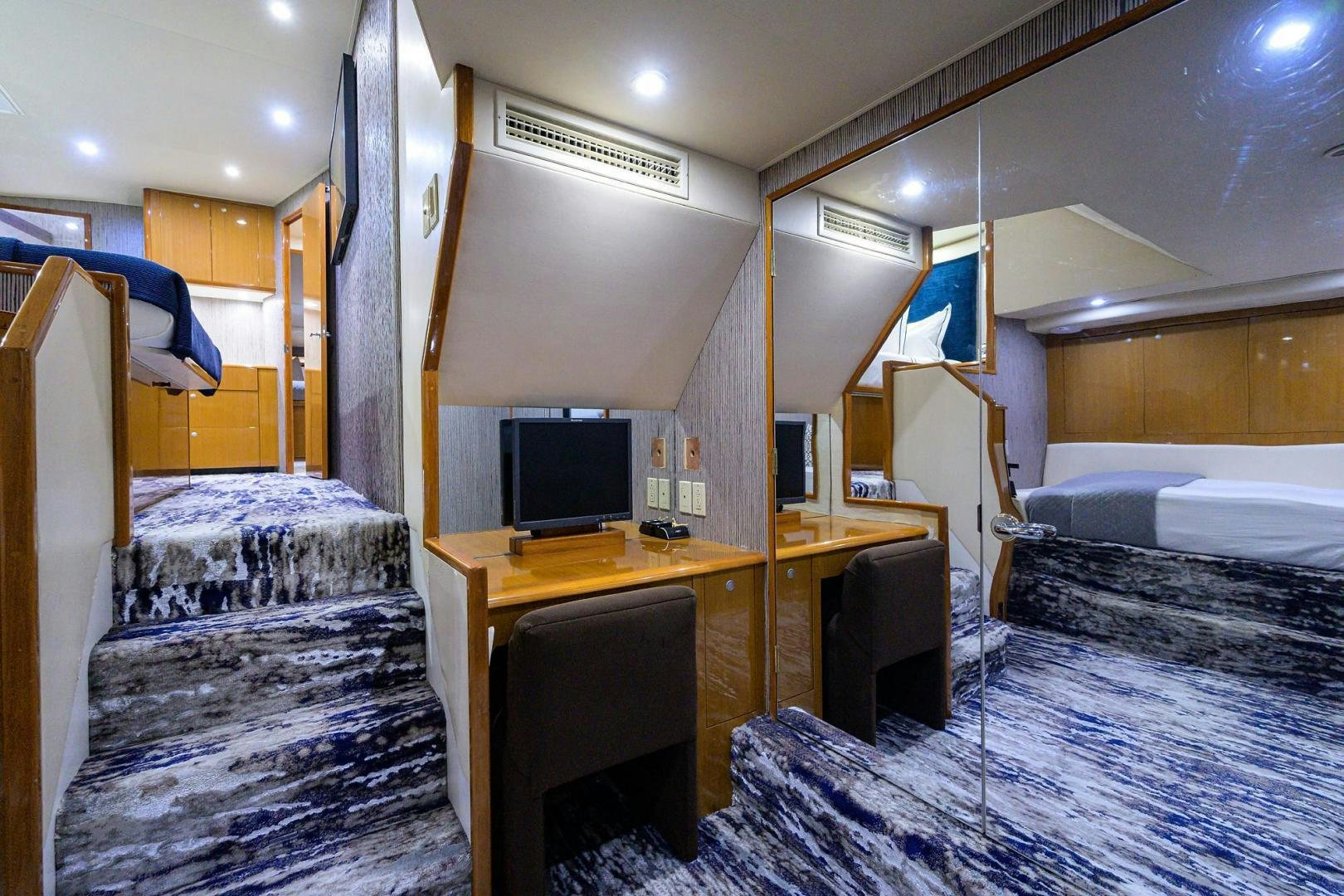 a room with a desk and a bed aboard VAGRANT Yacht for Sale