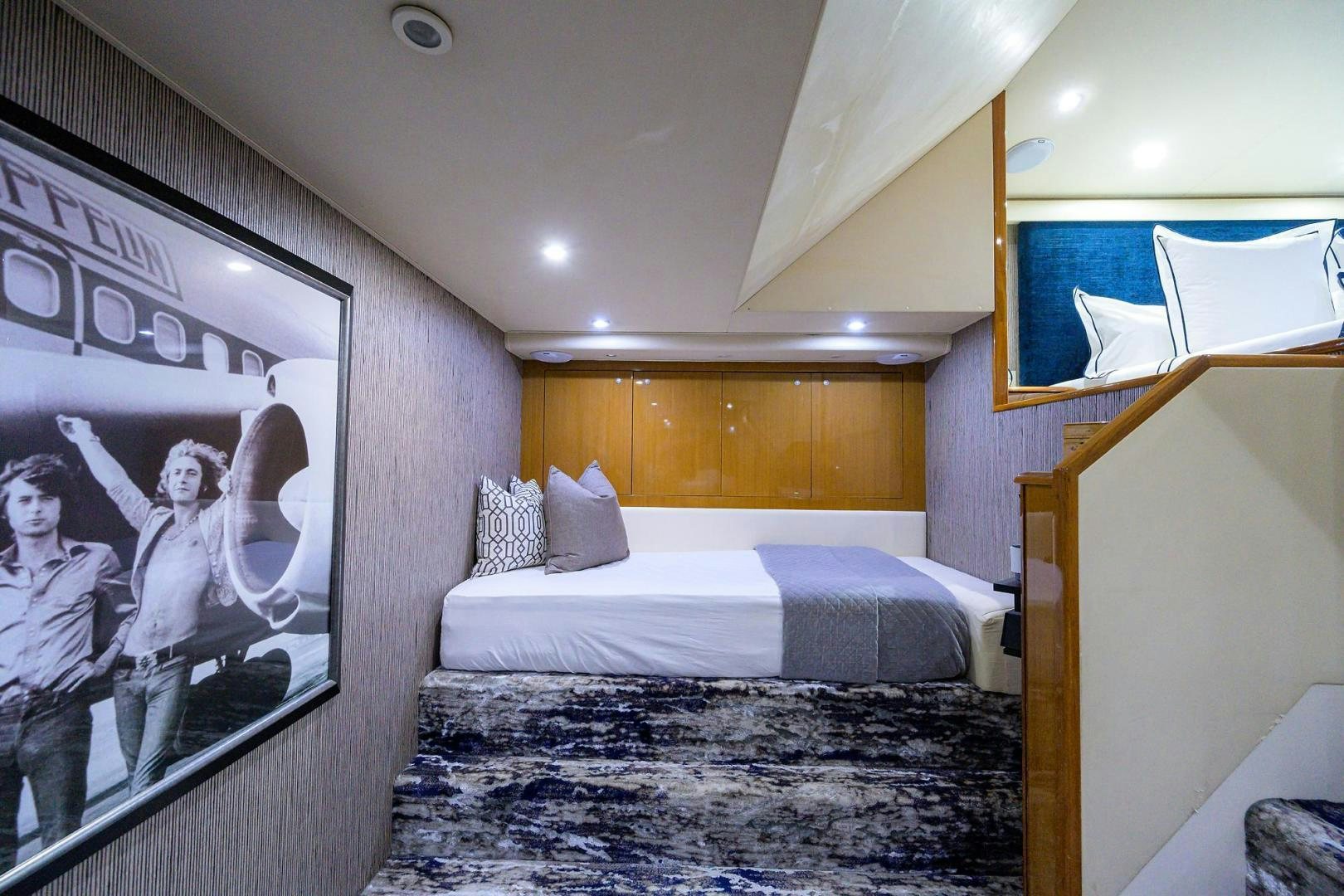 a room with a bed and a painting on the wall aboard VAGRANT Yacht for Sale