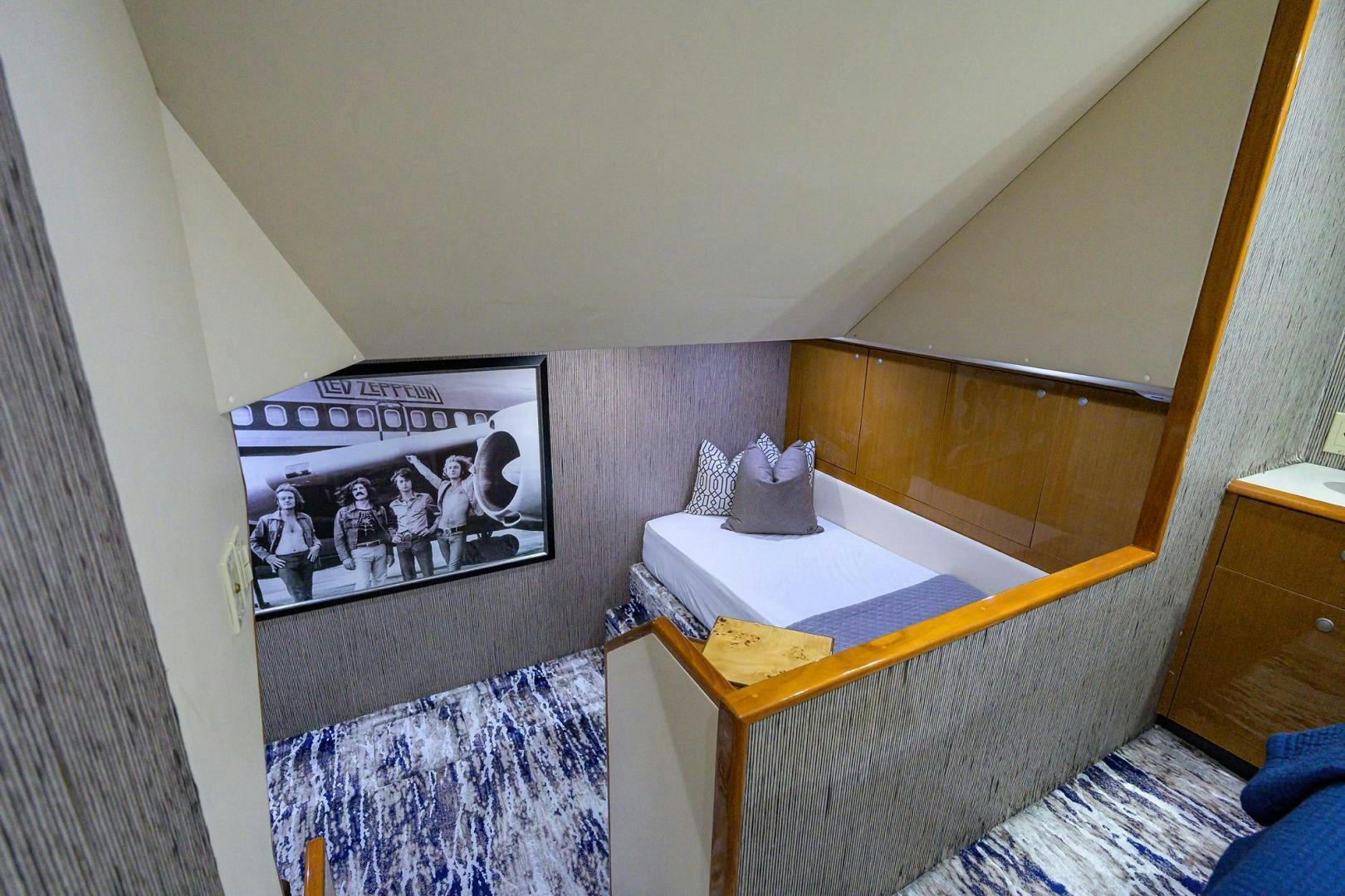 a bedroom with a bed and a television aboard VAGRANT Yacht for Sale