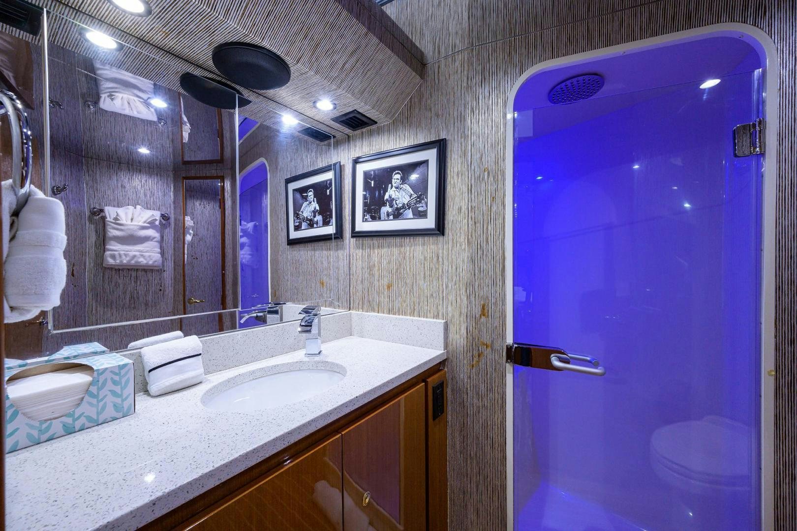 a bathroom with a blue shower curtain aboard VAGRANT Yacht for Sale
