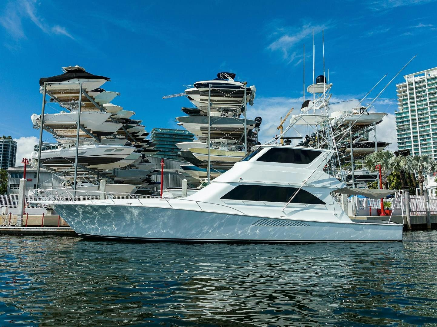a large white boat in a harbor aboard VAGRANT Yacht for Sale