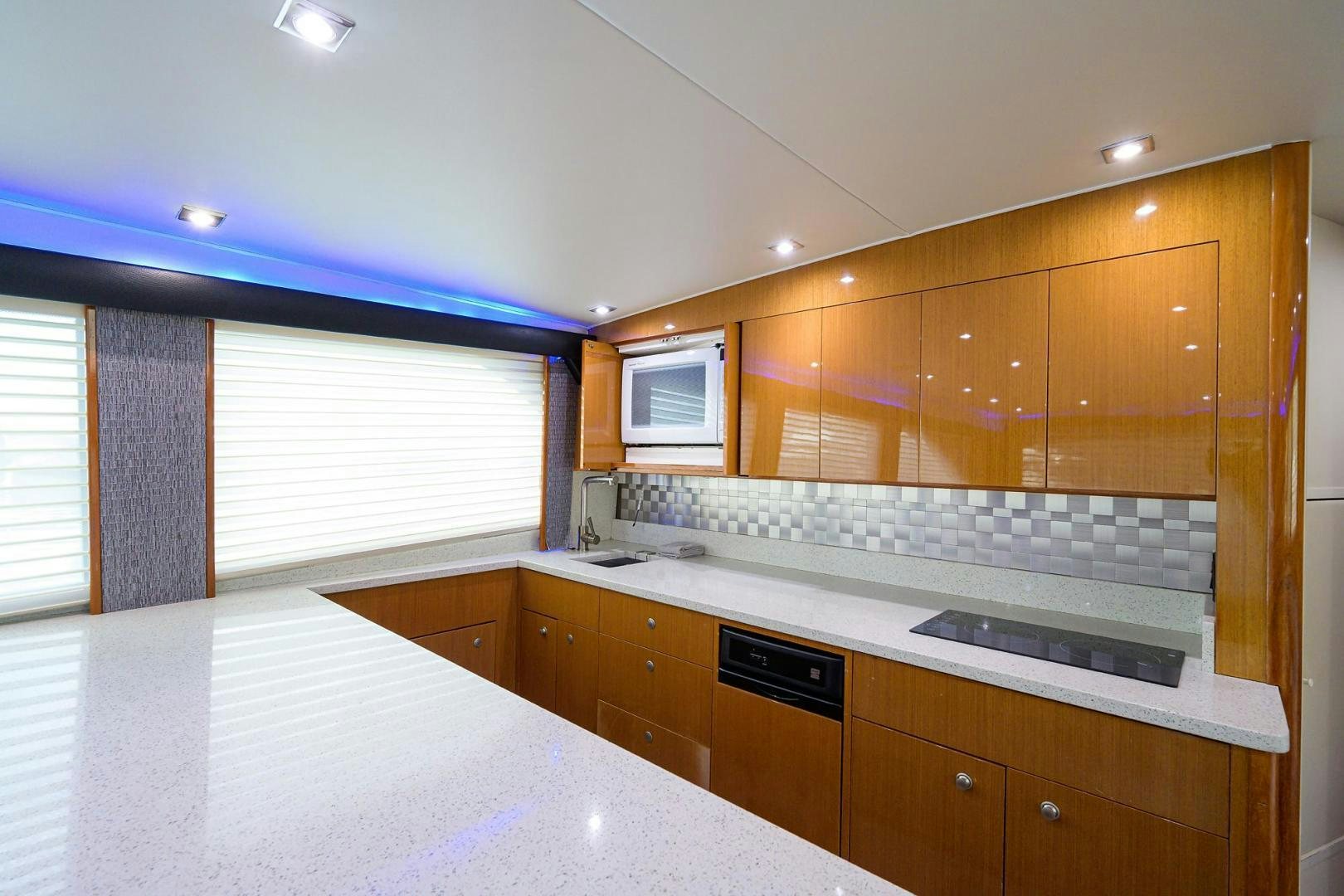 a kitchen with white cabinets aboard VAGRANT Yacht for Sale