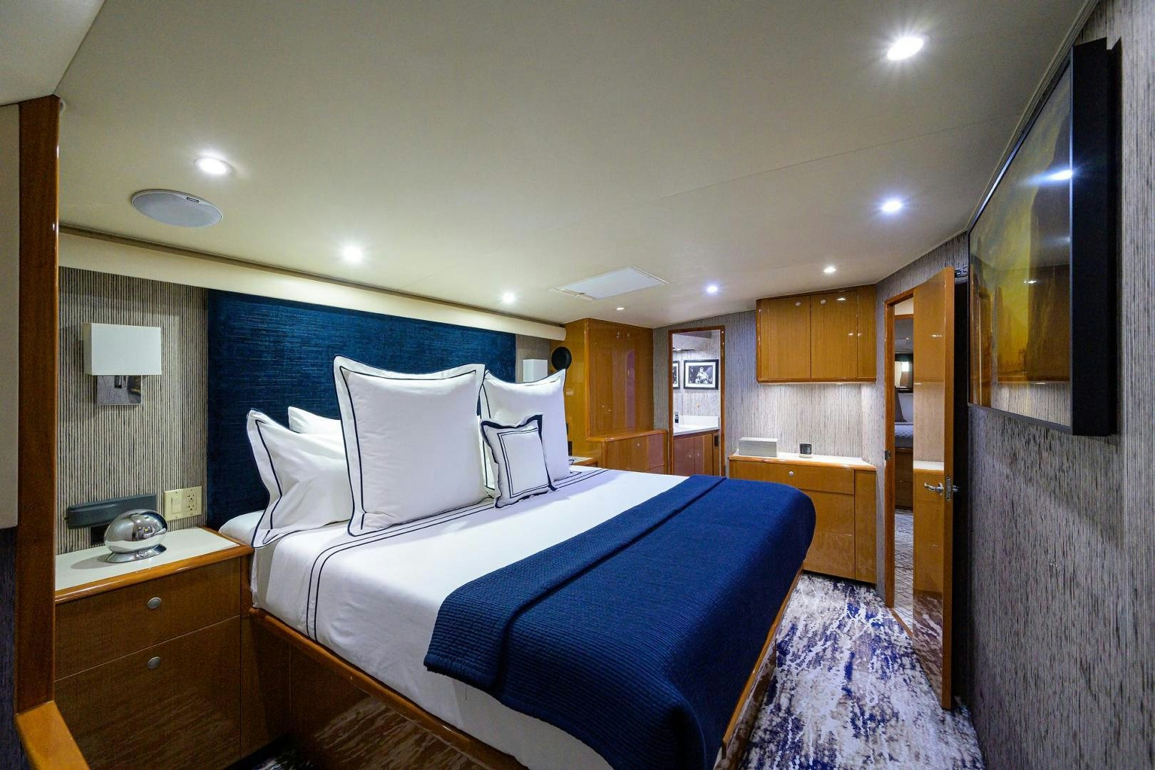 a bedroom with a bed and a desk aboard VAGRANT Yacht for Sale