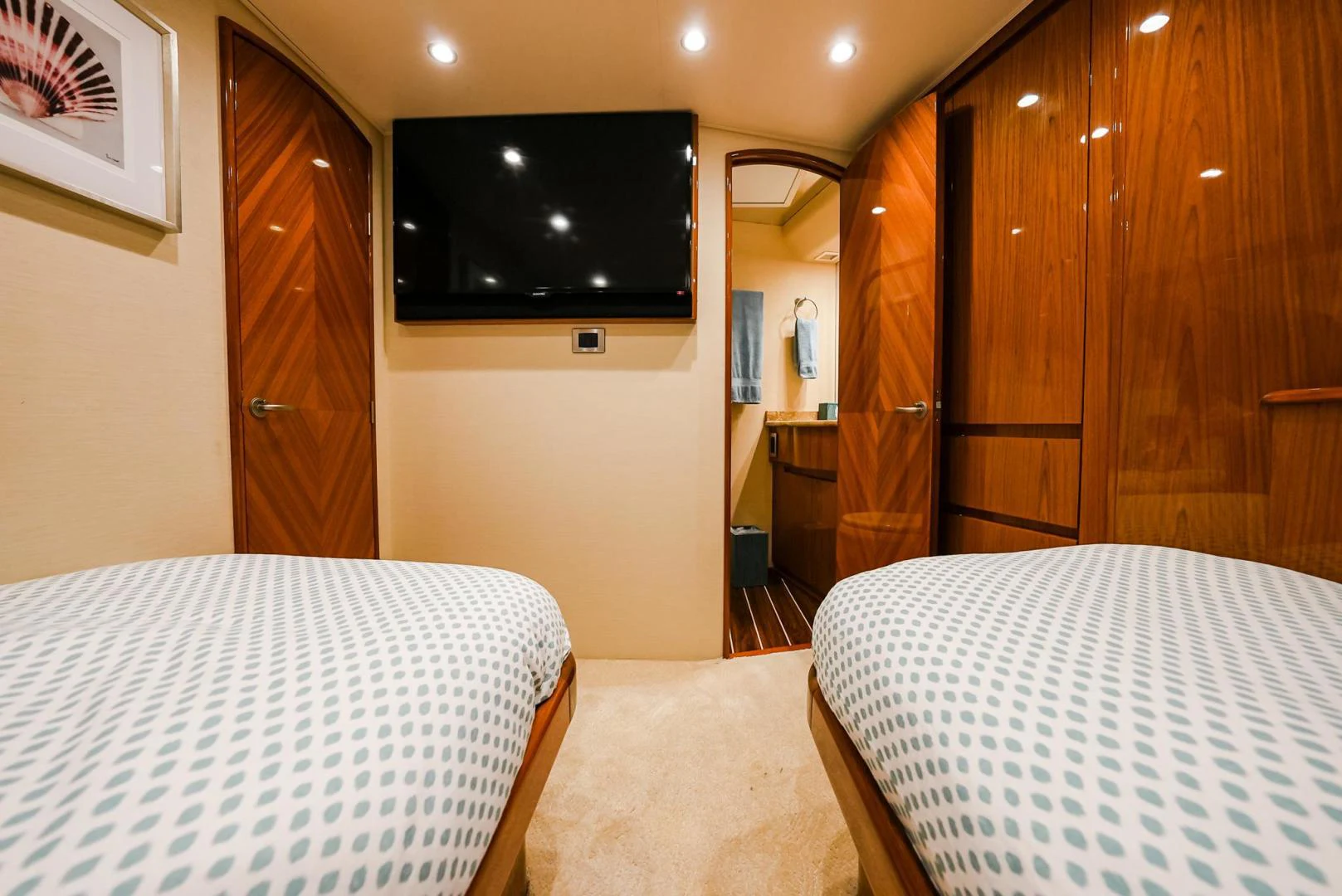 a hotel room with a tv and beds aboard PANACEA Yacht for Sale