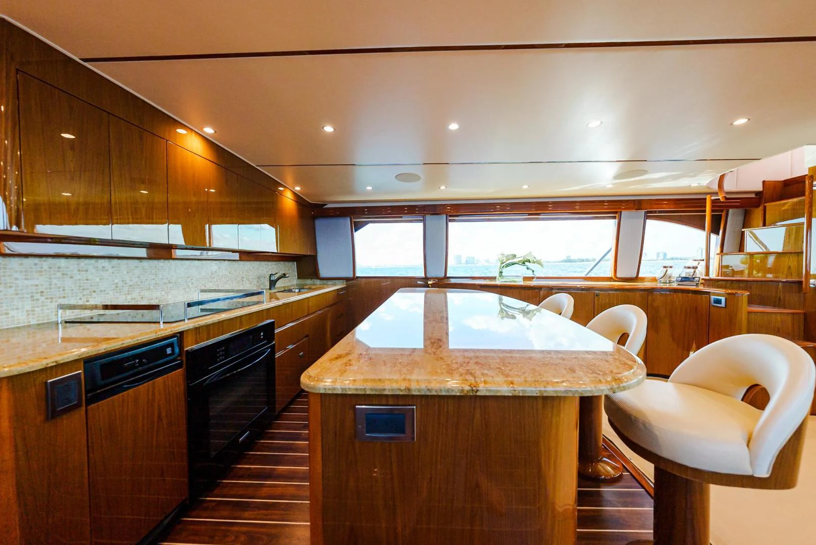 a kitchen with a bar and a table aboard PANACEA Yacht for Sale