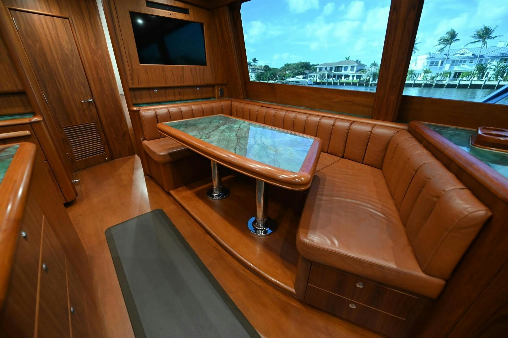 a couch and a table in a room aboard TANGAROA Yacht for Sale