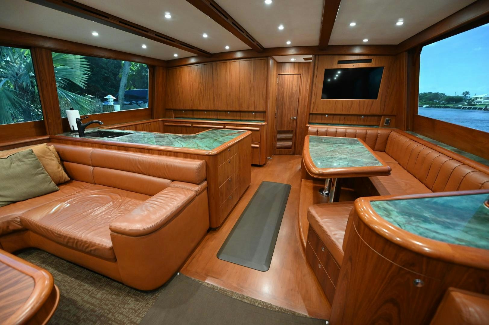 a room with a pool table and couches aboard TANGAROA Yacht for Sale