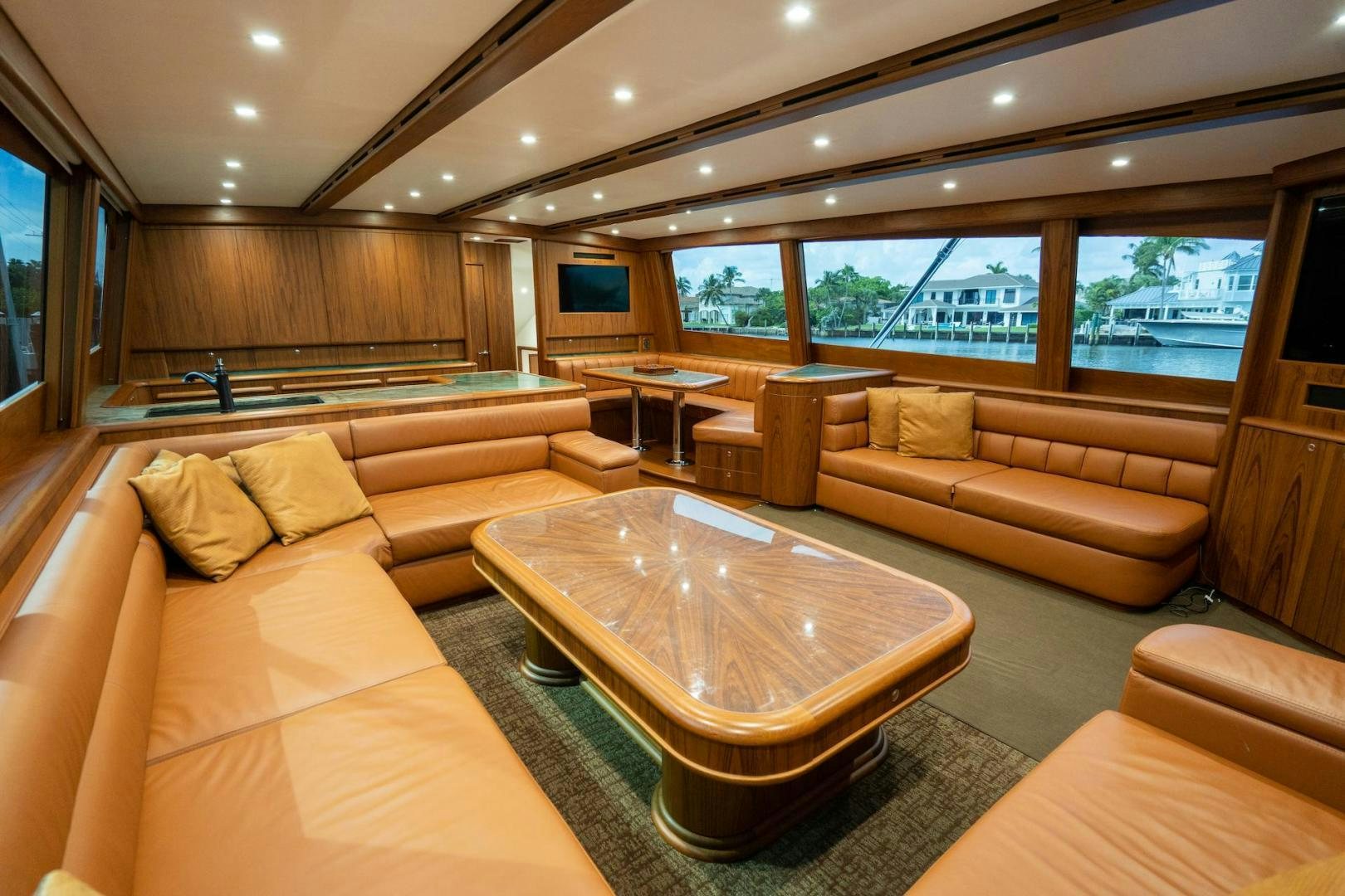 a living room with a couch and a coffee table aboard TANGAROA Yacht for Sale