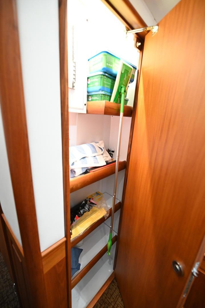 a wooden closet with shelves and a shelf with objects on it aboard TANGAROA Yacht for Sale