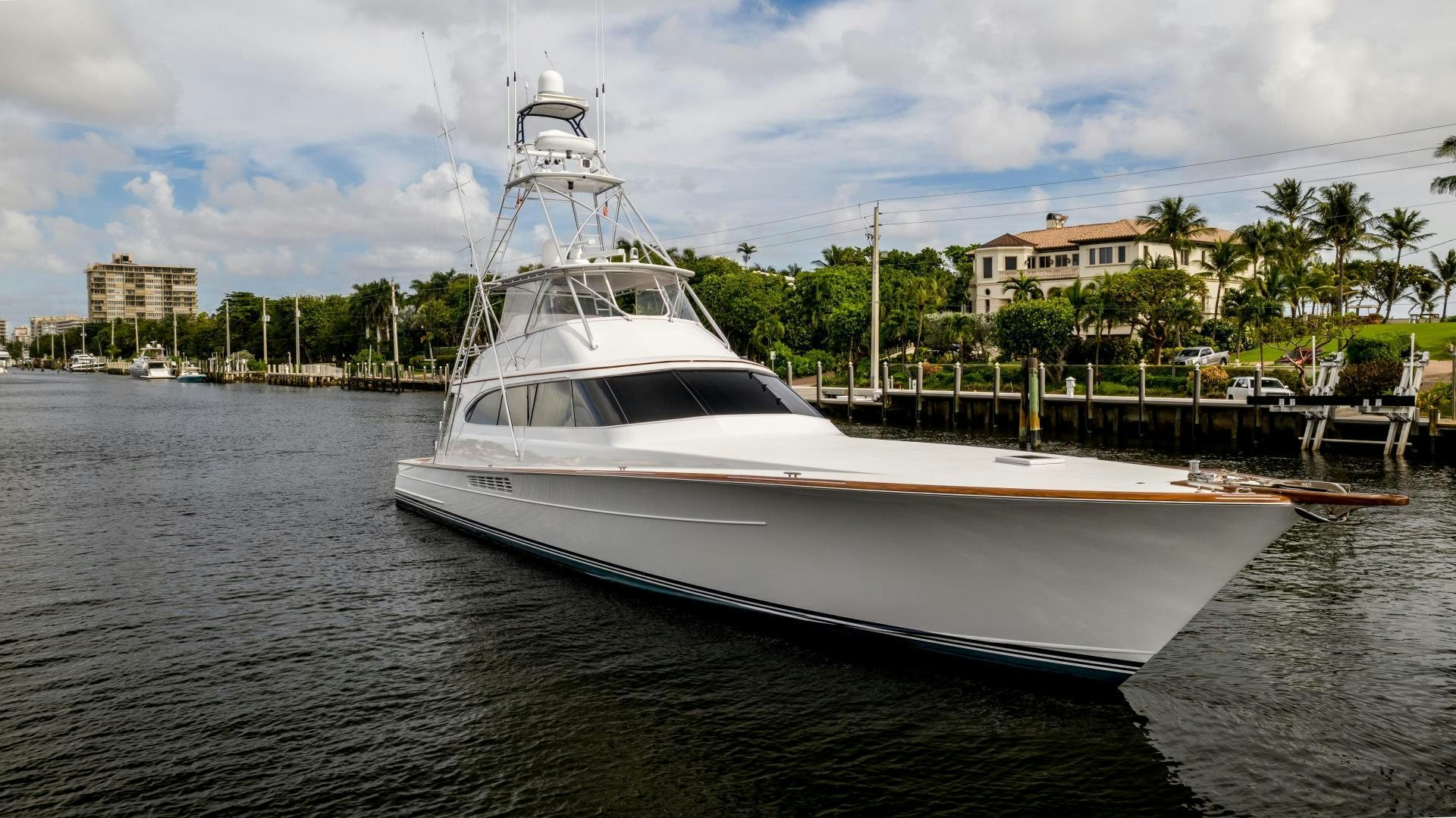 a white yacht docked at a dock aboard TANGAROA Yacht for Sale