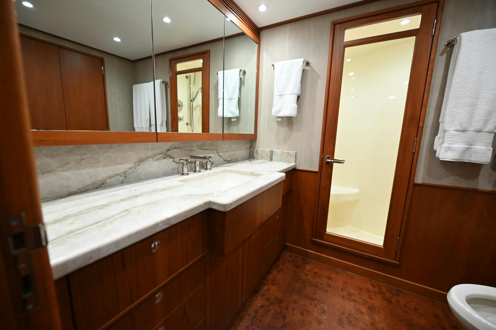 a bathroom with a large mirror aboard TANGAROA Yacht for Sale