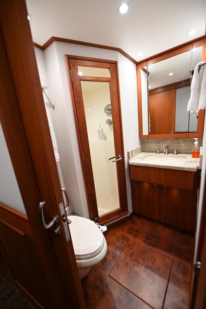 a bathroom with a toilet and a sink aboard TANGAROA Yacht for Sale