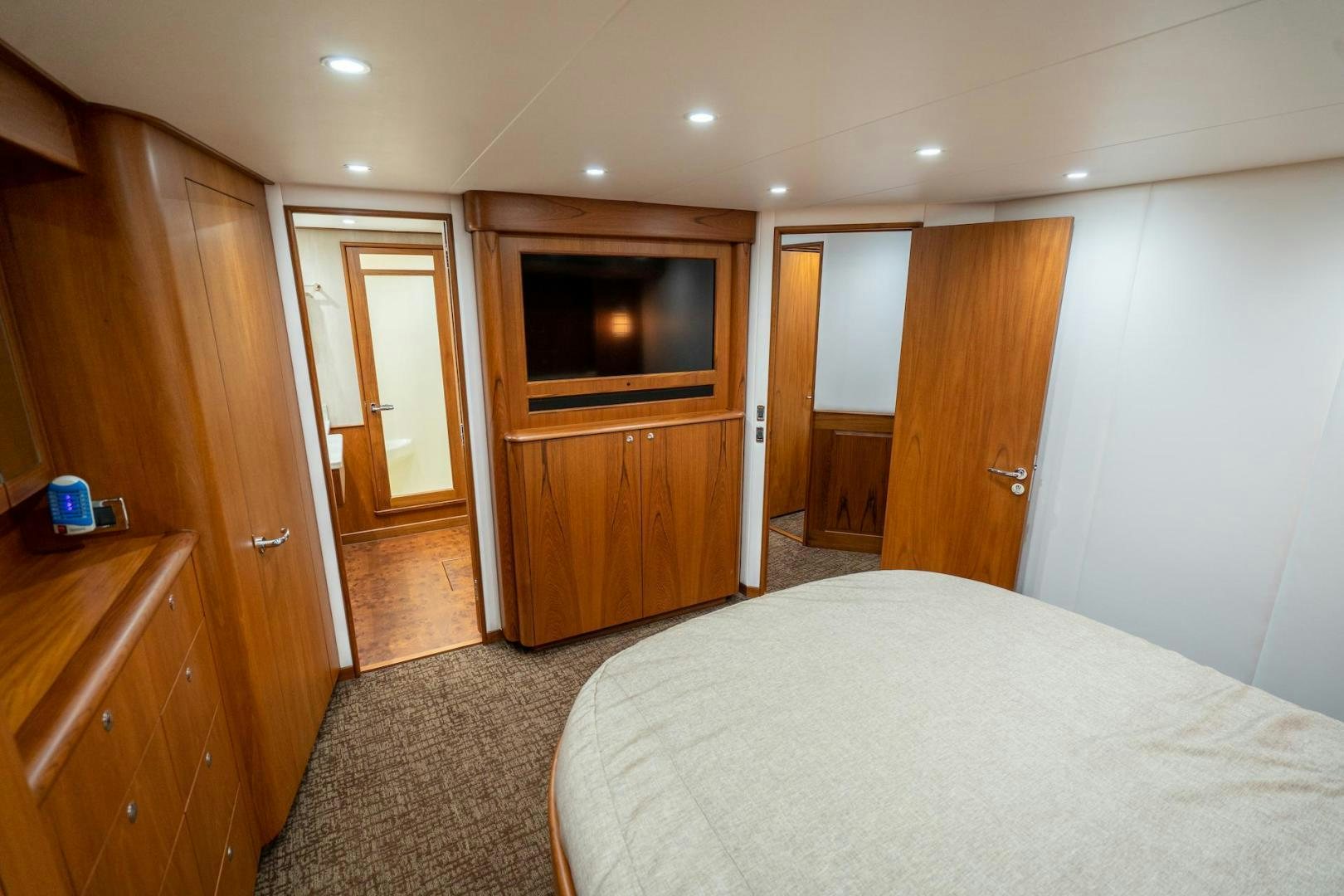 a bedroom with a bed and a television aboard TANGAROA Yacht for Sale