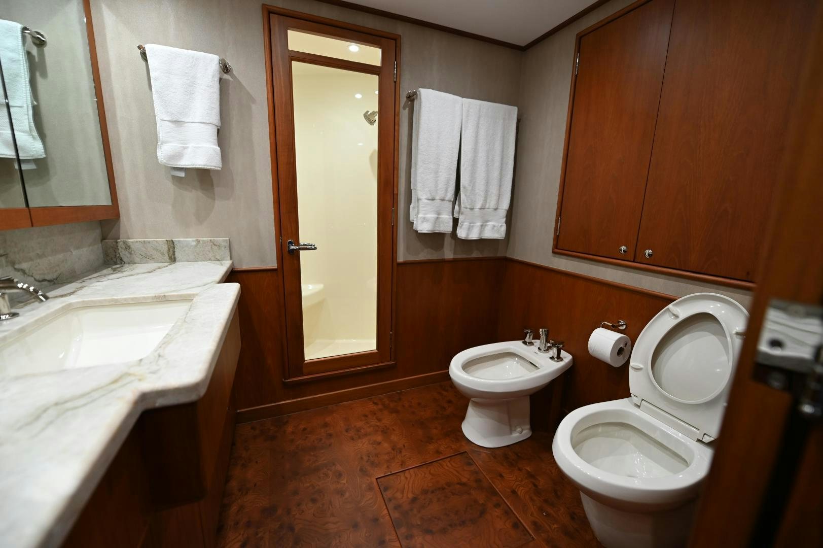 a bathroom with a toilet and sink aboard TANGAROA Yacht for Sale