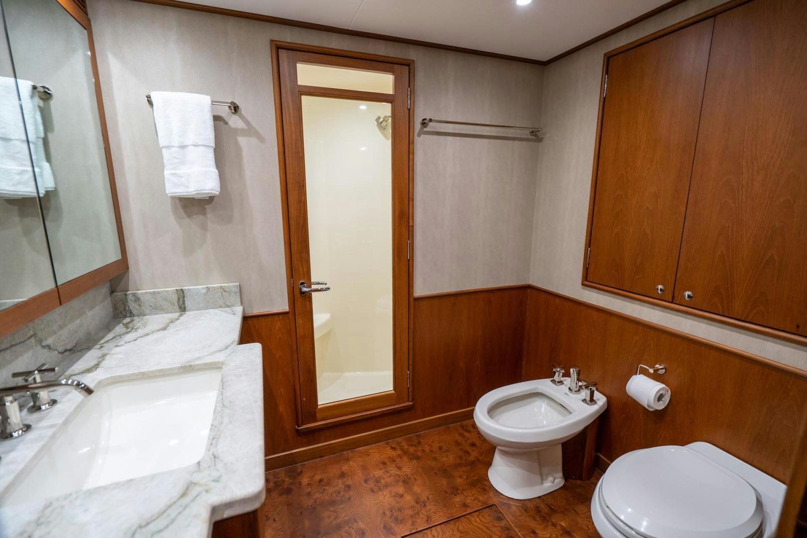 a bathroom with a toilet and sink aboard TANGAROA Yacht for Sale