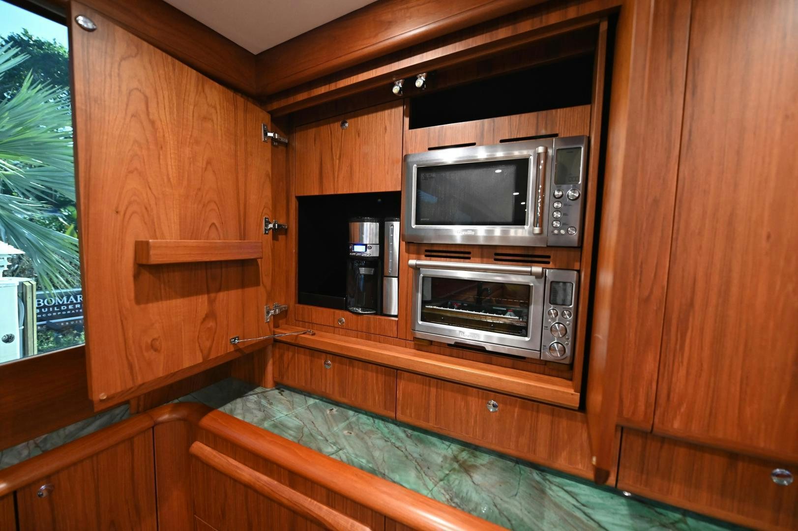 a wooden cabin with two microwave ovens aboard TANGAROA Yacht for Sale