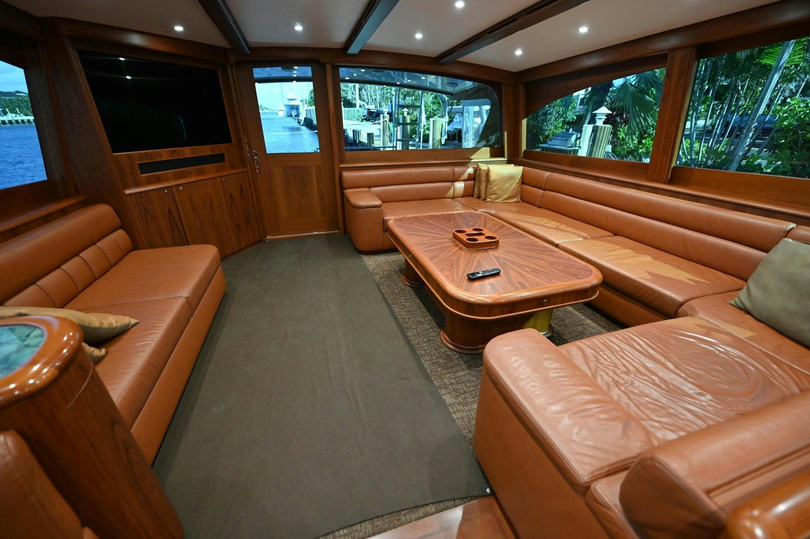 a living room with a table and couches aboard TANGAROA Yacht for Sale