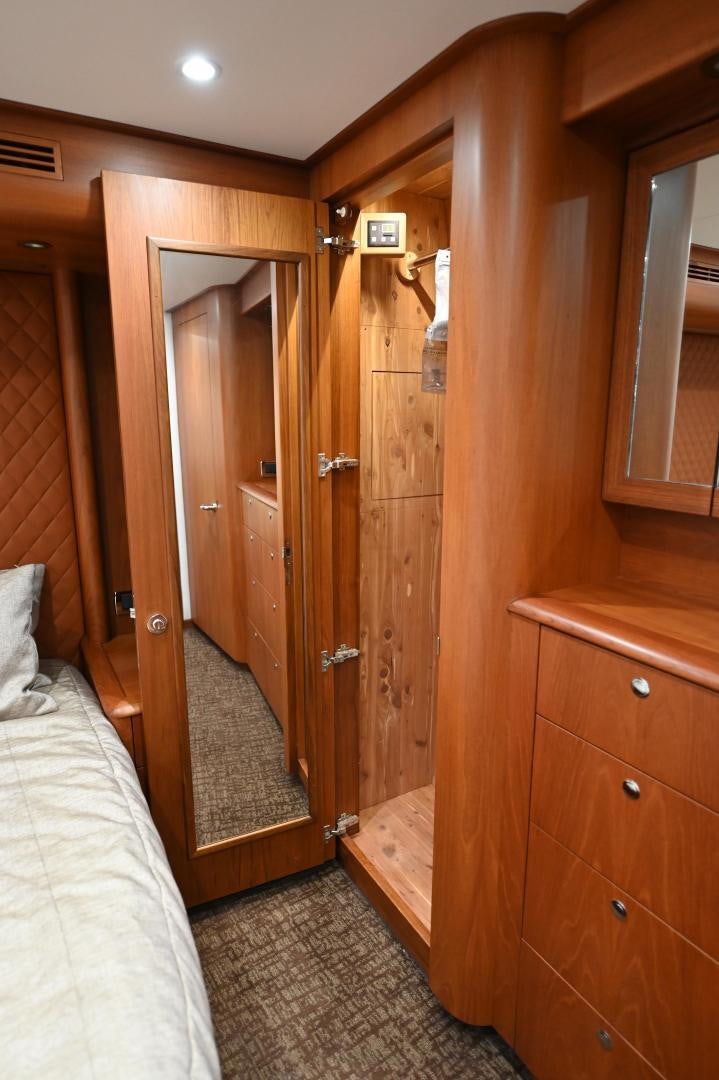 a bathroom with a wood door aboard TANGAROA Yacht for Sale