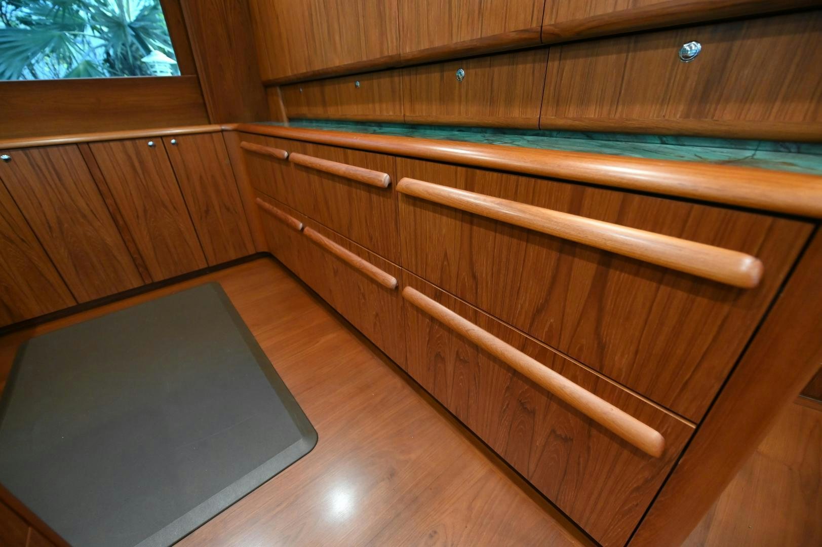 a wooden desk with a computer aboard TANGAROA Yacht for Sale