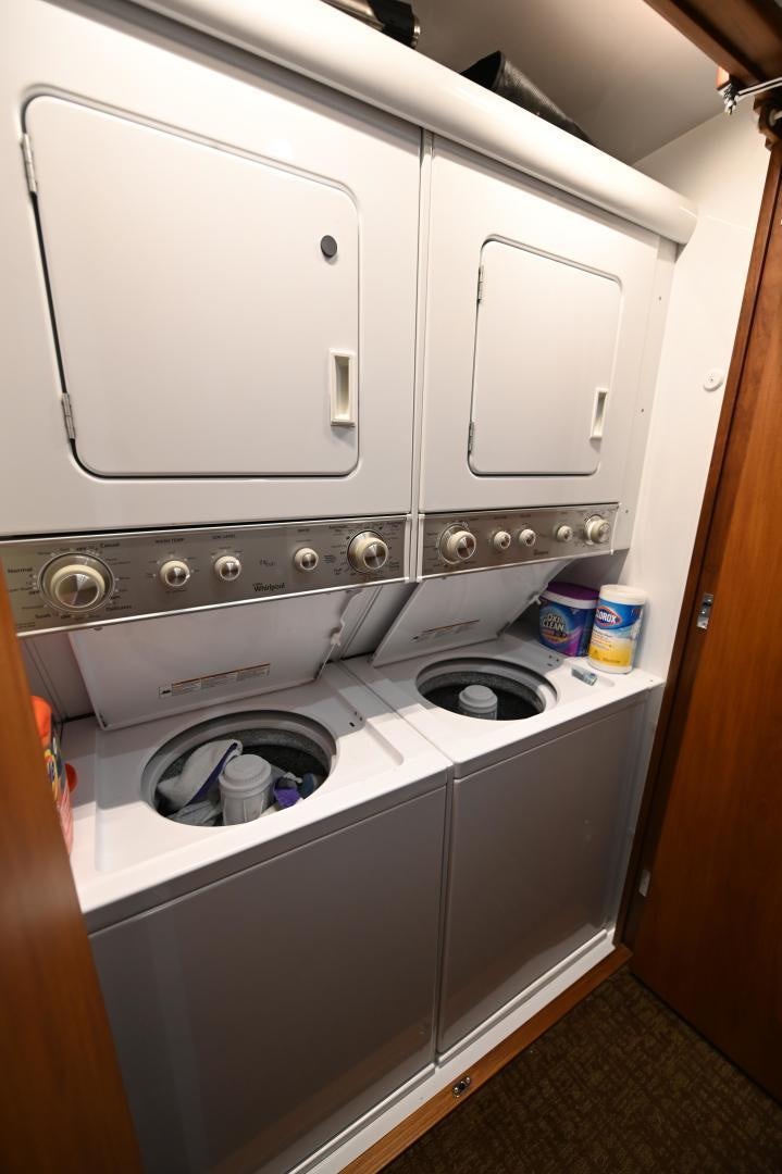 a white kitchen with a silver stove aboard TANGAROA Yacht for Sale